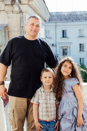 Portrait of a father with his daughter and son in the city