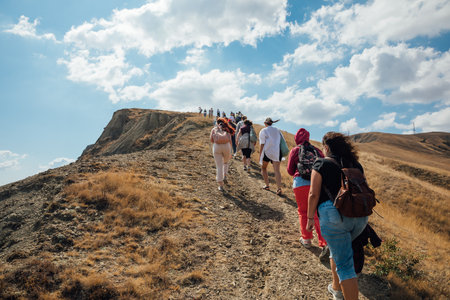 People hiking climbing to the top of the mountainの写真素材