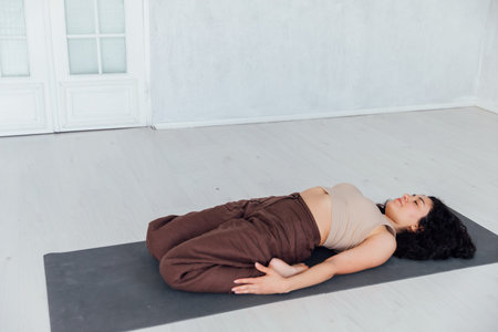 Young yogi woman practicing yoga concept, doing One Legged King Pigeon exercise, Eka Pada...