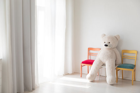 two chairs AND GIFTS TOY MEDEDA in the interior of an empty white room with a windowの写真素材