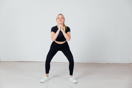 Beautiful woman squatting fitness sportsの写真素材