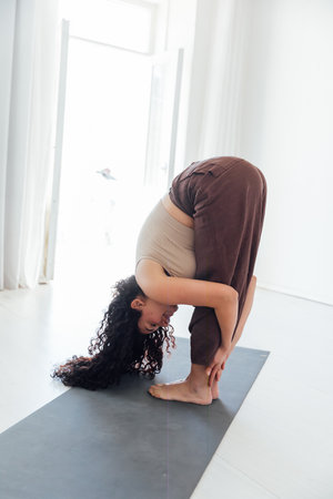 woman doing gymnastics yoga asanaの写真素材