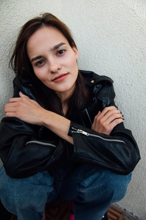 Portrait of a fashionable slender woman in a black leather jacket
