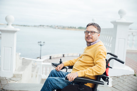 Man sitting in a wheelchair on a walk