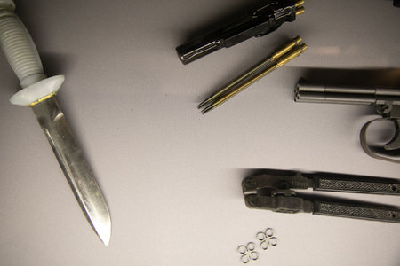 Diving knife and naval underwater pistol on a gray backgroundの写真素材