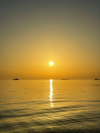 Silhouettes of ships on the horizon of the seaの写真素材
