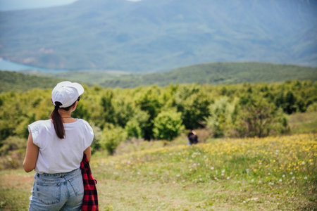 traveler looking at the view from the top of the mountain on a hikeの写真素材