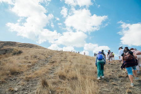 A group of tourists climbing to the top of a mountain on a trip