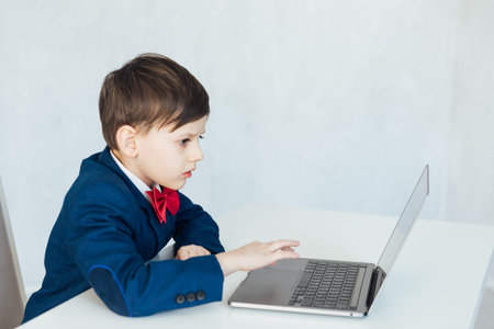 Boy In Business Suit Studying Playing On Laptop