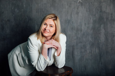 Business woman 45 years old in white suitの写真素材