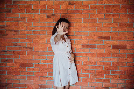 Brunette woman 40 years old shows five fingersの写真素材