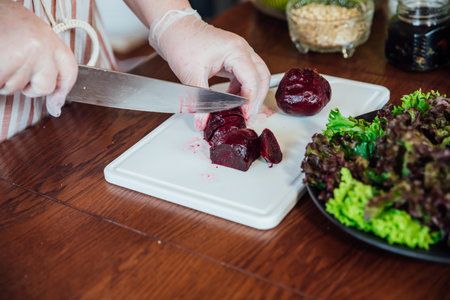 Housewife blonde cook cooking in the kitchenの写真素材
