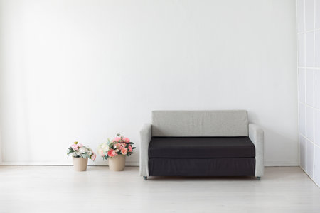 Black and gray sofa and flower baskets in the interior of a roomの写真素材