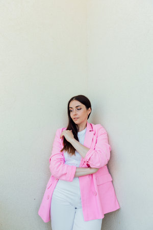 Brunette woman in suit with pink jacketの写真素材