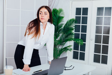 Business woman at desk, work laptop in office onlineの写真素材