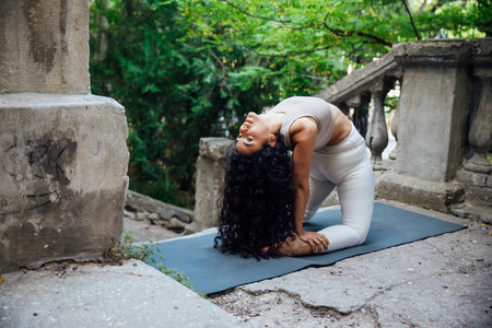 woman doing gymnastics yoga asana outdoorsの写真素材