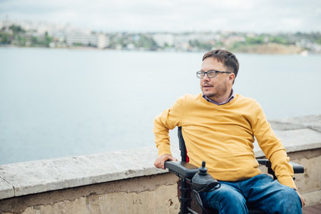 man in a wheelchair came to the sea to seeの写真素材