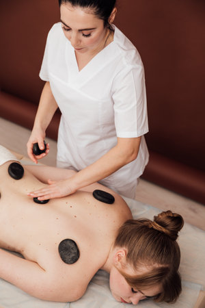Doctor Massage Therapist Gives Woman Back Massage In Spaの写真素材