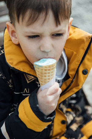 Little boy eating delicious ice creamの写真素材