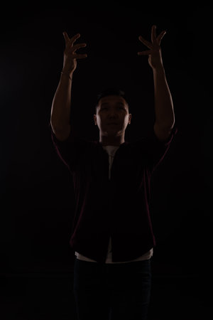 Asian man dancing to music aloneの写真素材