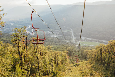 Landscape with empty funicular carts on forest mountain
