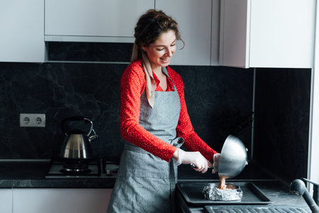 Woman in red dress preparing food in kitchen for dinner