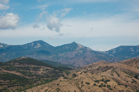 Beautiful landscape from the top of the mountain to the forest and blue sky with cloudsの写真素材