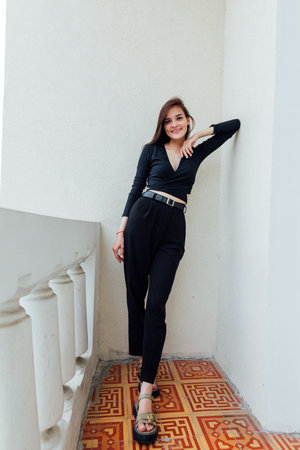 Portrait of a beautiful slender young brunette girl in black clothesの写真素材