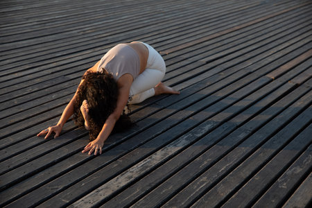 athletic brunette woman doing gymnastics yoga asanaの写真素材