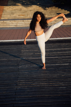 athletic brunette woman doing gymnastics yoga asanaの写真素材