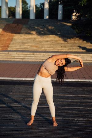 athletic brunette woman doing gymnastics yoga asanaの写真素材