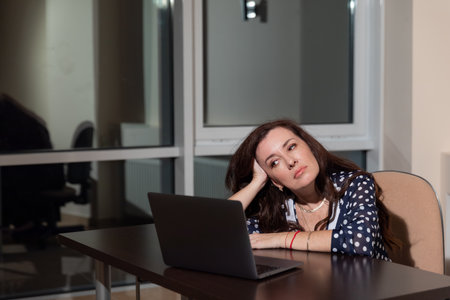 woman working on laptop online at desk in officeの写真素材