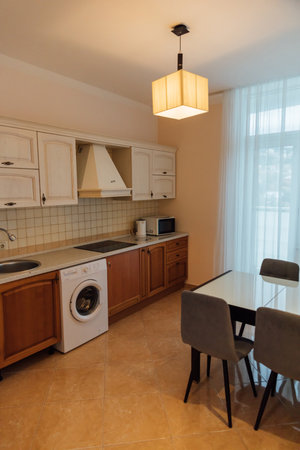 Kitchen interior with table and washing machineの写真素材