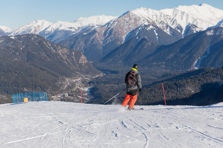Skiers, snowboarders skiing in a mountain ski resort