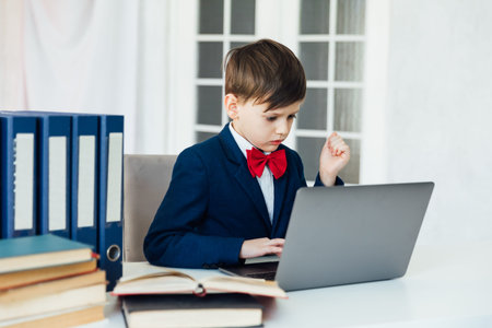 Boy In Business Suit And Tie Working On Laptop Online