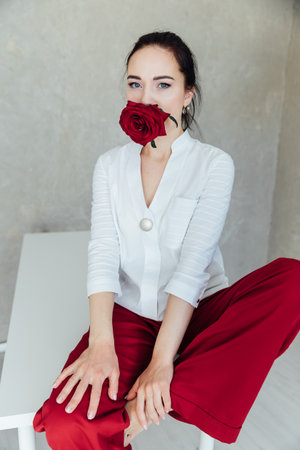 Portrait of Beautiful Fashion Brunette Woman in Red Pants and White Shirtの写真素材