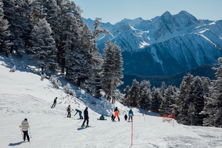 Snowboarders and skiers ski in the ski resort on the slopesの写真素材