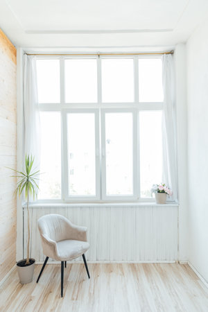 Interior of an empty white room with a window