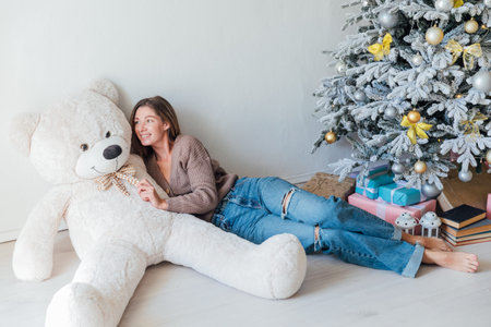 Woman in Home Clothes with New Year Giftsの写真素材