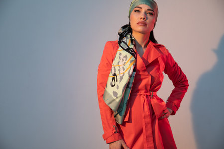 Portrait of a beautiful fashionable slim brunette woman in a red summer dressの写真素材
