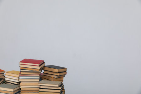 Stacks of old educational books for study in the library on a white backgroundの写真素材