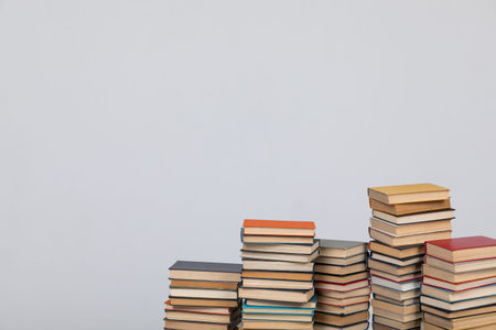 Stacks of old educational books for study in the library on a white background