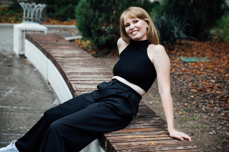 Portrait of a beautiful young fashionable woman in a black suit