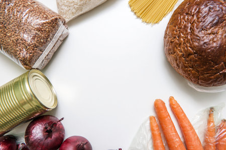 Set of raw cereals, grains, pasta and canned food on a white table. Copy space, flat lay. Crisis food stock for coronavirus quarantine isolation period. Food delivery, donationの写真素材