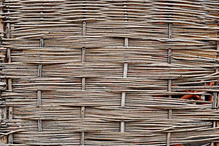 Close-up view of beautiful decorative brown wicker fence background
