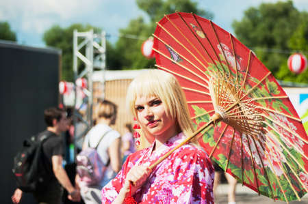 Russia, Moscow-July 21, 2019: Japanese culture festival j-FEST, cosplay girl with a Japanese outfit with an umbrella.のeditorial素材