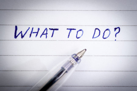 Blue pen lettering on What to do paper and a pen with a vignette.