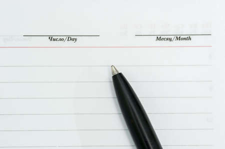 The pen is on the diary, month, date, plans,の写真素材