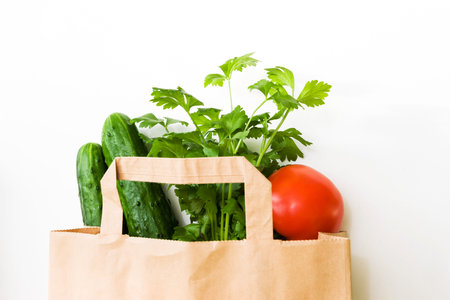 Supermarket concept of vegetarian food shopping, top view in a paper bag.