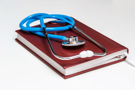 Blue stethoscope lying on the diary, medicine.の写真素材